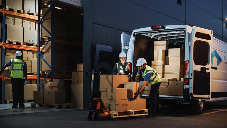 Professional staff load a lloyd's logistics truck with boxes of important cargo